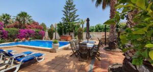 Outside table area with pool view